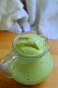 Photo of avocado dressing in small glass pitcher